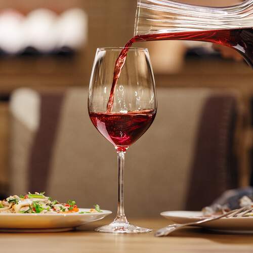 Pouring Red Wine from Carafe