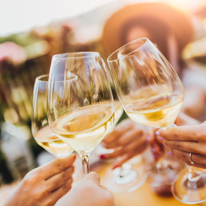 White wine glasses toasting