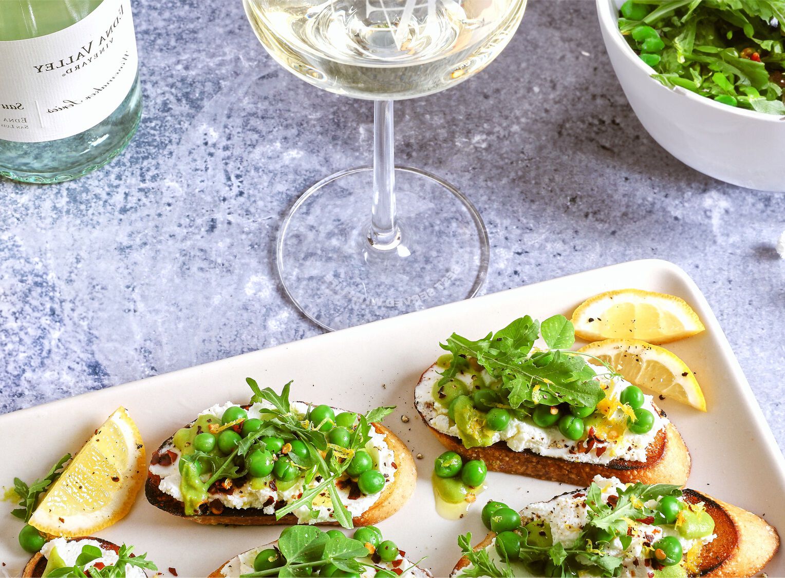 Crostini with Whipped Ch&egrave;vre, Ricotta, and Lemony Pea Pur&eacute;e Recipe Image