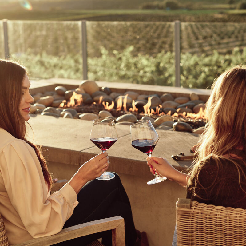 two women drinking red wine